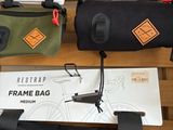 three bags that are on a shelf in a store