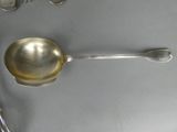 a silver spoon and a spoon rest on a table