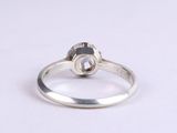 a close up of a silver ring on a white surface