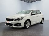 the white car is parked in a large white room