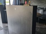 a kitchen island with a vase of flowers on top of it