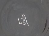 a close up of a black and white vase on a table
