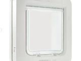 a close up of a white cat flap door on a white wall