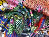 brightly colored fabric with a bird and fish design on it