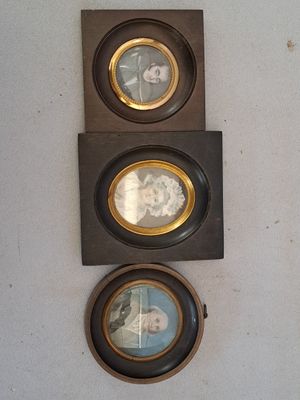 three framed pictures hanging on the wall of a room