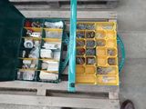 a green case filled with assorted tools on a pallet