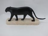 figurine of a black cat walking on a marble base