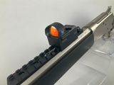 a close up of a gun with a red dot on it