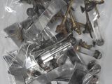 a bag of assorted metal parts on a white surface