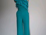 turquoise one shoulder jumpsuit with ruffles on a mannequin