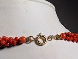 an image of a red beaded necklace on a mannequin mannequin