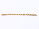 a close up of a gold bracelet on a white surface