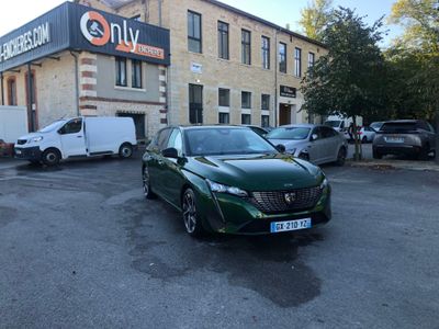 a green car parked in front of a building in a parking lot