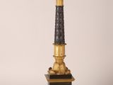 a black and gold candelier on a pedestal