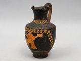 a black vase with an elephant painted on it