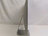 a computer monitor sitting on a stand on a white surface