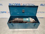 a blue box with a drill in it sitting on a table