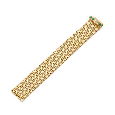 a gold bracelet with emerald stones