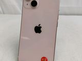 a close up of the back of a pink iphone with a red sticker on it