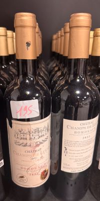 several bottles of wine are lined up on a shelf in a store