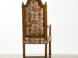 a wooden chair with a patterned upholstered back