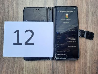 an image of a cell phone sitting on top of a table next to a paper