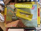 a pile of books on a table with a train in the background