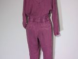 a close up of a mannequin wearing a purple suit on a mannequin stand