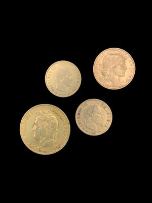 four different types of gold coins on a black background