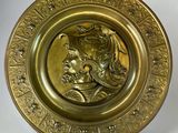 gold plate with a portrait of a man and a woman on it
