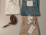a pair of pants, a shirt, a belt, and a pair of scissors on a table