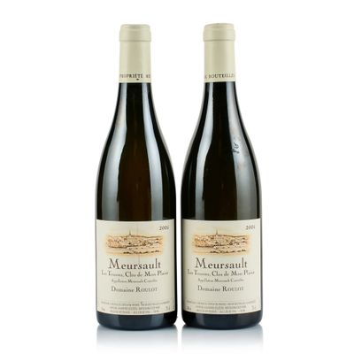 two bottles of wine sitting next to each other on a white surface