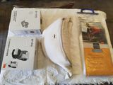 two boxes of toilet paper, a toilet brush, and a toilet roll