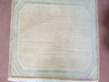a beige rug with fringes and fringes on it