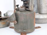 an old gas can sitting on a table next to other items