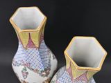two vases that are sitting on a black surface