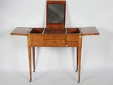 a small wooden table with a mirror on top of it