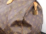 a louis vuitton bag sitting on a black surface