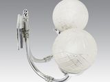 pair of white glass ball sconces mounted on a metal wall