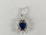 a blue sapphire and diamond pendant on a white background