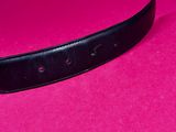 a black belt on a pink surface