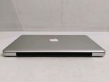 a silver apple laptop sitting on a white surface