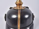 an old black and gold bell on a white background