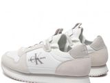 the sneakers are white and grey with a logo on the side