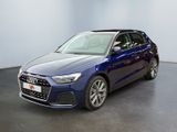 a blue audi q3 parked in a room with a white wall