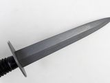 a close up of a knife with a black handle on a white surface