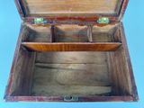 a wooden box with two compartments open on a blue background