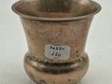 a silver vase that has a price tag on it