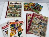 several books of comics and cartoons on a white surface
