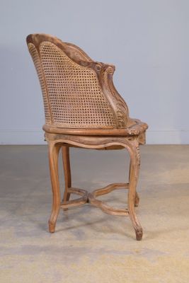 Fauteuil de bureau en bois mouluré et canné.